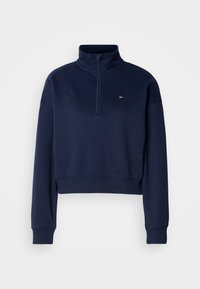 Navy cropped sweatshirt with a high collar and quarter zip. Features ribbed cuffs and hem, with a small logo at the chest. Soft texture.