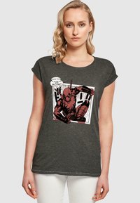 Mørkegrå kortærmet T-shirt med et grafisk print af en tegnestuefigur, med klare farver og en tale- eller tankeboble. Glat tekstur, afslappet pasform.