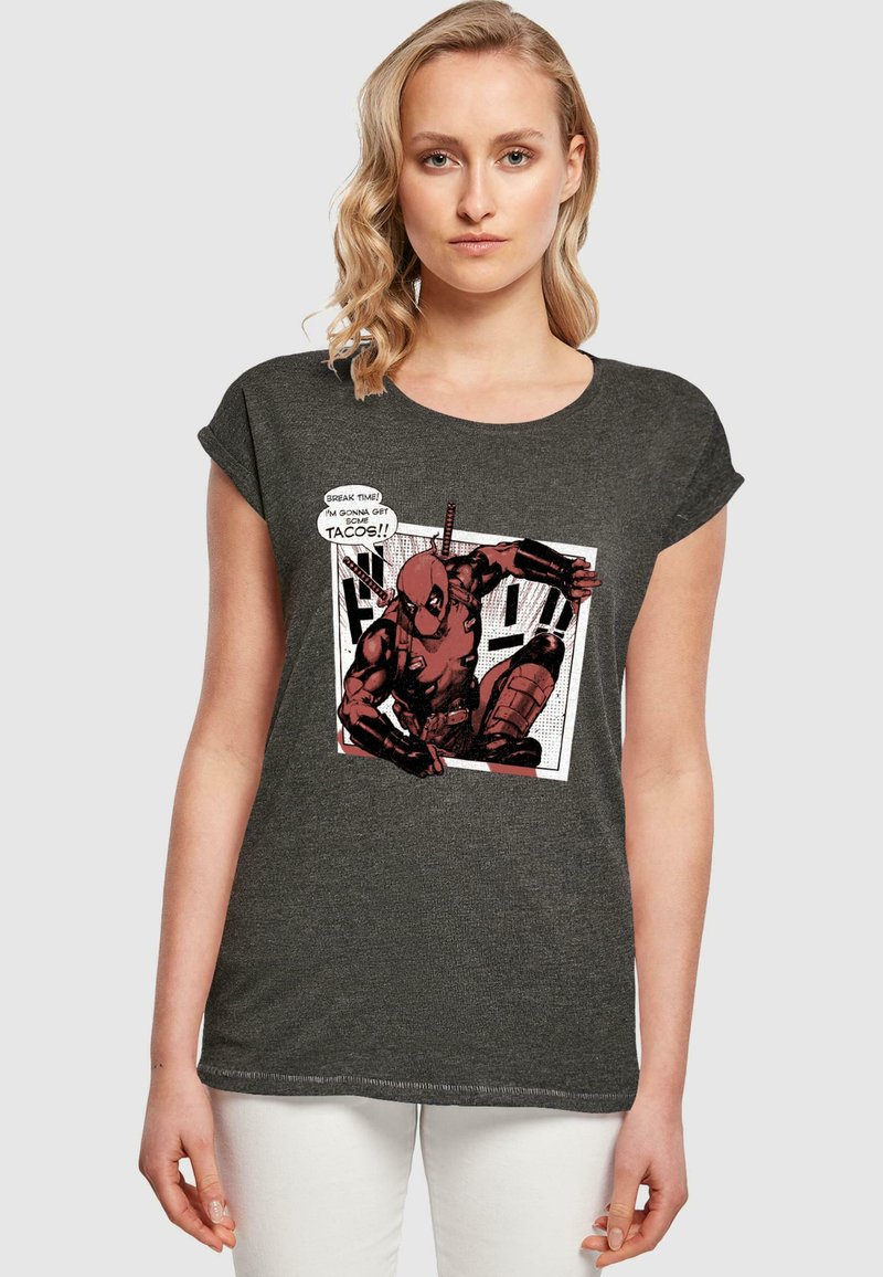 Mørkegrå kortærmet T-shirt med et grafisk print af en tegnestuefigur, med klare farver og en tale- eller tankeboble. Glat tekstur, afslappet pasform.