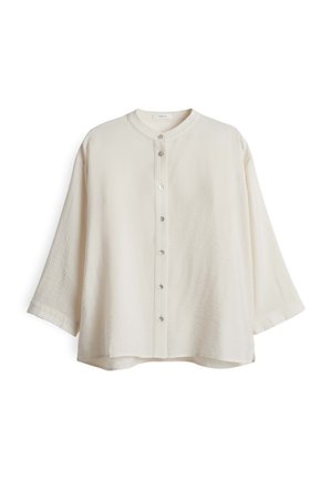 Hellbeige übergroßes Shirt mit rundem Ausschnitt, Knopfverschluss vorne und Dreiviertelärmeln. Weicher, strukturierter Stoff mit lockerer Passform.