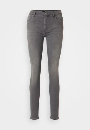 Jeans skinny in denim grigio, con vita alta, chiusura con zip e tasche frontali. Il tessuto presenta una leggera texture e un leggero sbiadimento.
