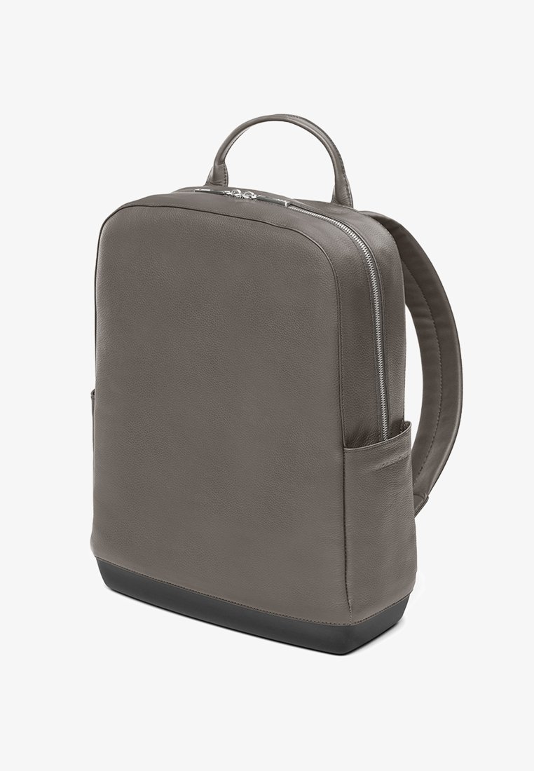Gray leather backpack with a sleek design, rounded corners, a top handle, and a side pocket. Features a contrasting black base and silver zippers.