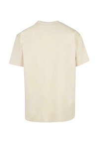 Kortærmet t-shirt med rund hals i lysebeige bomuld. Enkel design uden mønstre eller detaljer, med en lige kant og afslappet pasform.