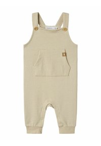 Bodysuit beige à côtes avec bretelles ajustables, boutons en bois, poche frontale et fermetures à pression au bas pour un habillage facile.