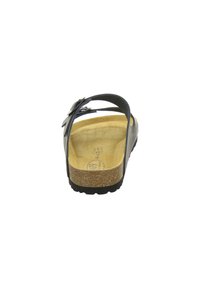 Black sandal with adjustable strap, cork footbed, and rubber outsole. Textured surface and minimalist design with a flat heel.