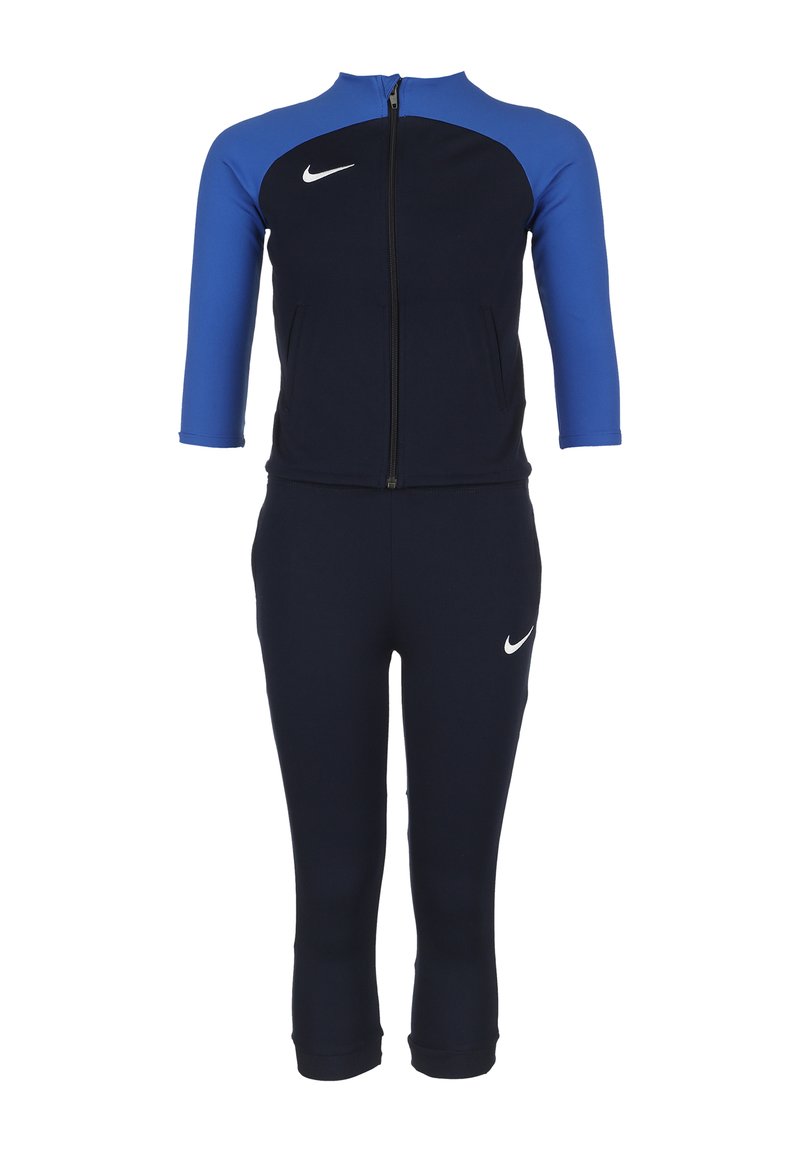 Tuta sportivo navy e blu con zip, maniche a tre quarti e logo Nike bianco in evidenza. Realizzato in materiale elasticizzato.