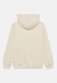 Φούτερ με κουκούλα σε κρεμ χρώμα από απαλό ύφασμα. Διαθέτει κουκούλα με κορδόνι και ριμπ μανσέτες. Χωρίς ορατά σχέδια ή διακοσμήσεις.