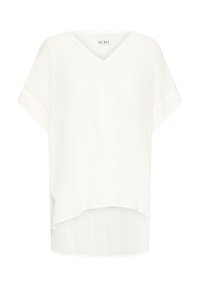 Top bianco a maniche corte con scollatura a V, realizzato in tessuto leggero con una sottile trama a coste e design con orlo asimmetrico.