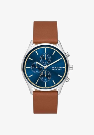 Orologio da polso Skagen con quadrante blu, cassa color argento, tre sub-quadranti, lancette argento, indici beige e cinturino in pelle marrone.