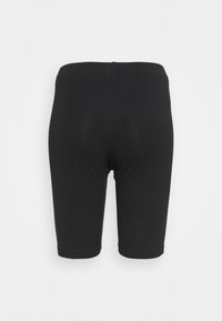 Zwarte fietsbroekjes van rekbare stof, met een hoge tailleband en een gladde textuur, ontworpen voor comfort en flexibiliteit.
