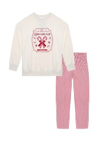 Felpa a maniche lunghe color crema con grafica rossa "CANDY CANE CLUB" e pantaloni da pigiama a righe rosse e bianche coordinati. Tessuto morbido e casual.