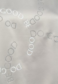 Light gray fabric with the words "GOOD BE DO DO GOOD" in white print and small rhinestones forming "DO GOOD" patterns.
