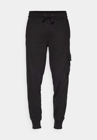 Svarta joggerbyxor i en bomullsblandning, med elastisk midja och snörning, sidofickor och ribbade muddar.