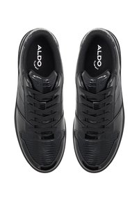 Black lace-up sneakers featuring a mix of smooth and textured patent leather, rounded toe, and "ALDO" branding on the insole.