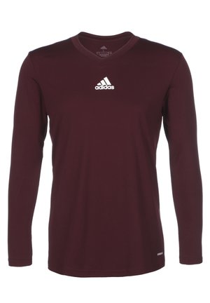 Vinrød Adidas atletisk langærmet skjorte med V-hals og hvid Adidas-logo centreret på brystet.