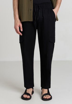 Calliope UNITA - Pantaloni cargo - nero