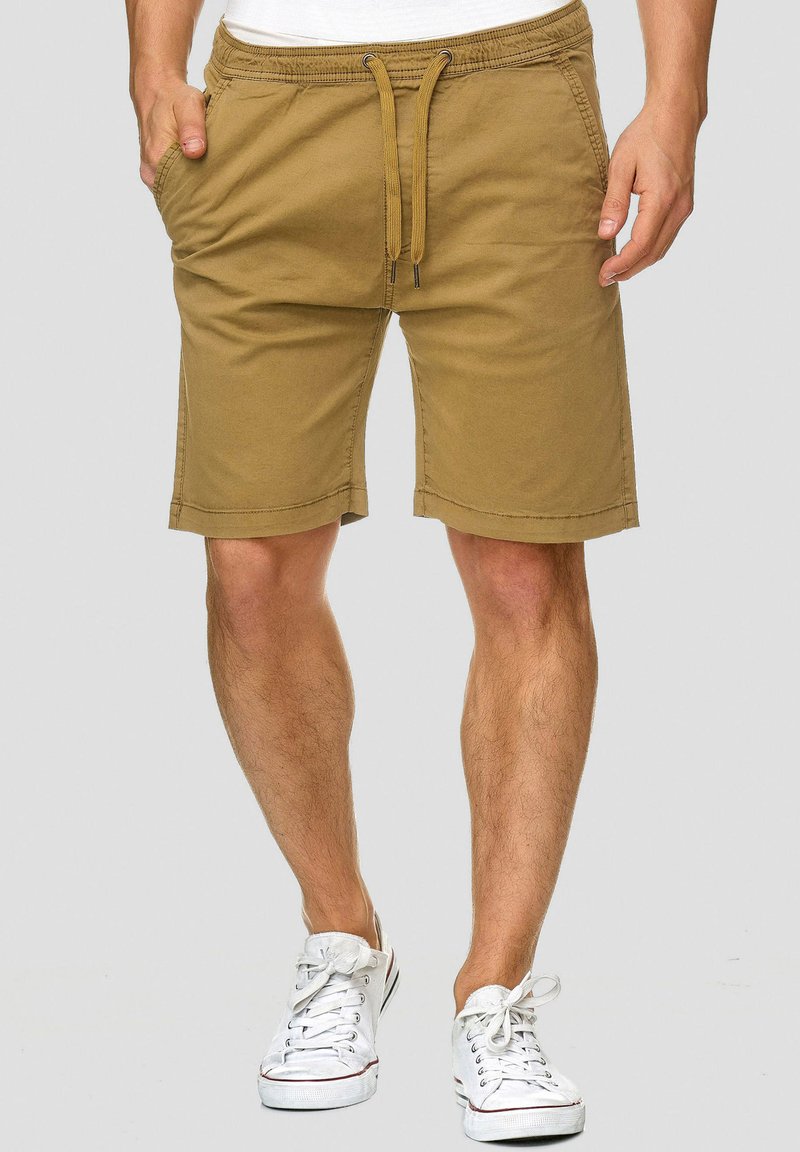 Shorts kaki avec une taille élastique et un cordon de serrage. Comprend deux poches latérales et une coupe droite, fabriqués à partir d'un mélange de coton doux.