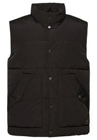 Svart pufferväst med hög krage, tryckknappar och två framfickor. Har quiltad struktur och kontrasterande grön insida.