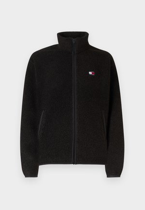 Czarna polarowa kurtka na suwak z wysokim kołnierzem, bocznymi kieszeniami i małym logo Tommy Jeans na lewej piersi.