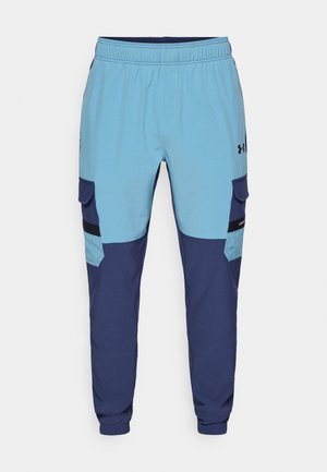 Pantalons de survêtement bleu et marine avec une taille élastique, des poches latérales et des accents de style cargo. Fabriqués en tissu doux et respirant.