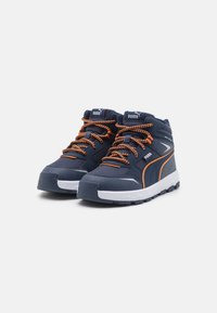 Marineblaue High-Top-Sneaker mit orangefarbenen Schnürsenkeln und Akzenten. Sie verfügen über ein strukturiertes Obermaterial, eine gepolsterte Sohle und eine weiße Sohle für Trittfestigkeit.