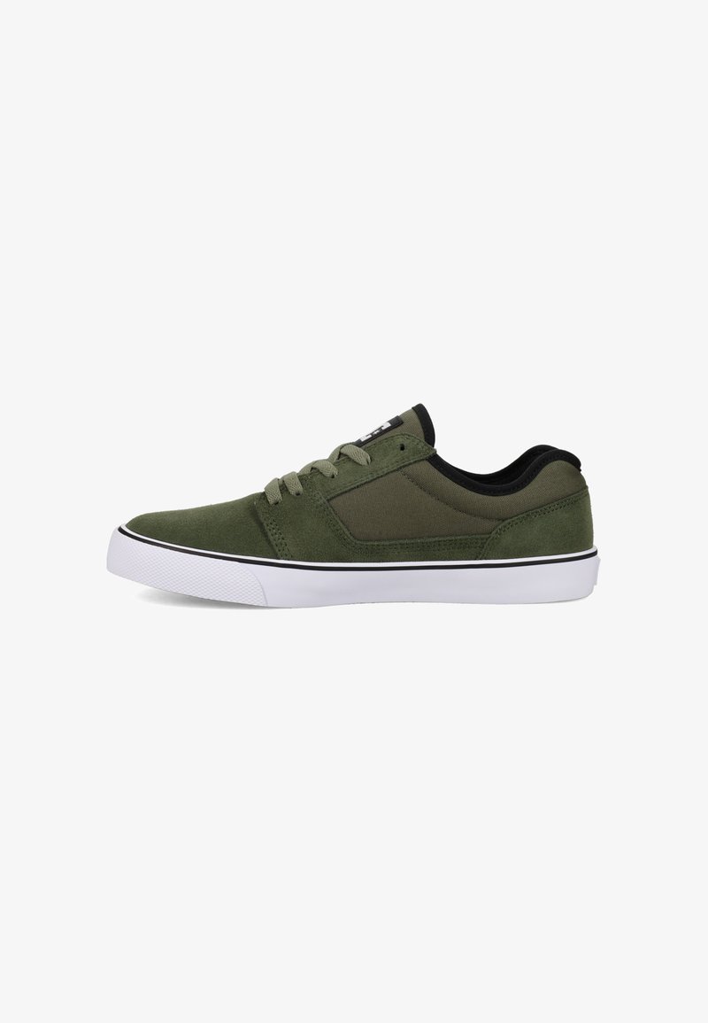 Green suede sneakers with black accents, featuring a low-top design, white rubber sole, and classic lace-up closure.
