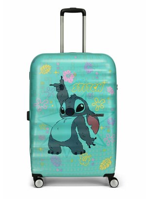 Valise rigide turquoise arborant un personnage de dessin animé, avec un motif en grille, des accents floraux colorés, une poignée rétractable et des roues.