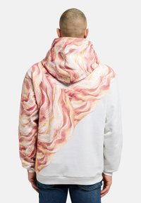 Hooded sweatshirt featuring a white body and multicolored textured design in pink and gold shades on the back and hood.