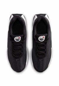 Black athletic shoes with a textured mesh upper, featuring a round logo on the tongue, black laces, and a white sole with a patterned tread.