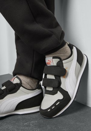 Black and gray athletic shoes with white accents, featuring two Velcro straps, a rubber sole, and a textured upper material.