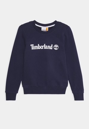 Granatowa bluza z długim rękawem i okrągłym dekoltem, z białym logo Timberland oraz emblematem drzewa na środku klatki piersiowej.