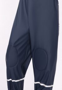 Jūras spēku ūdensnecaurlaidīgas bikses, izgatavotas no gludas materiāla, ar ceļgalu spilventiņiem un atstarojošu joslu gar malu redzam�ībai.