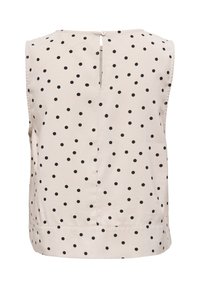 Blouse beige sans manches à pois noirs, fente dans le dos avec fermeture à bouton et ourlet droit.