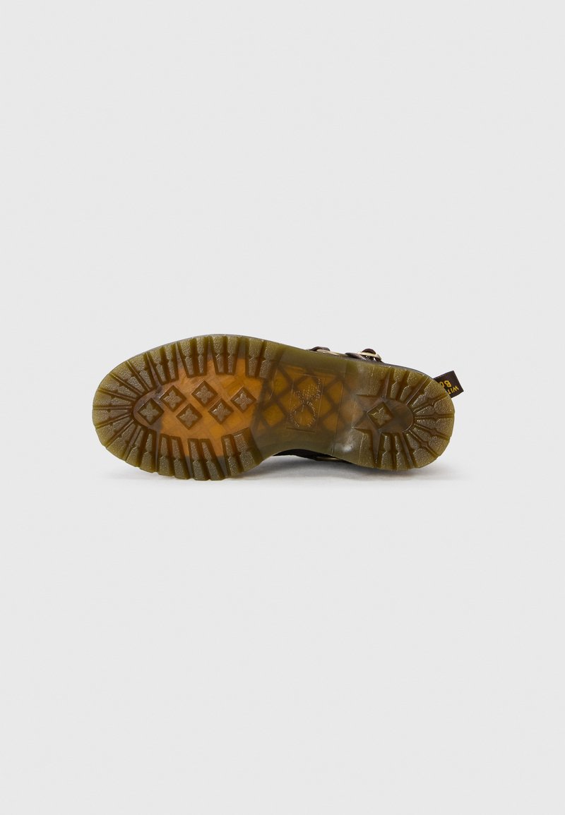 Semelle en caoutchouc brun avec un motif de semelle, dotée d'un design épais. Matériau durable et flexible, complété par un système de laçage.