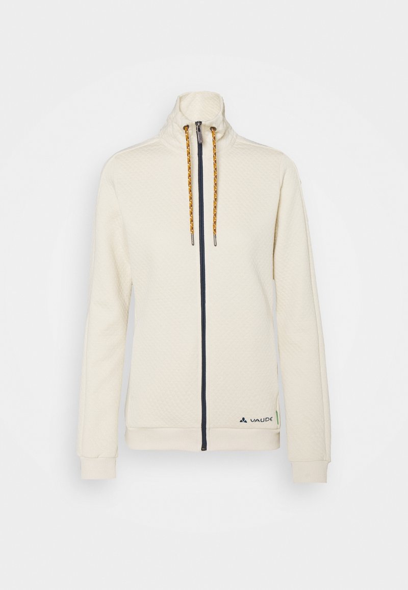 Veste crème à fermeture éclair avec col montant, cordons orange, poignets côtelés et logo Vaude sur la partie inférieure gauche devant.