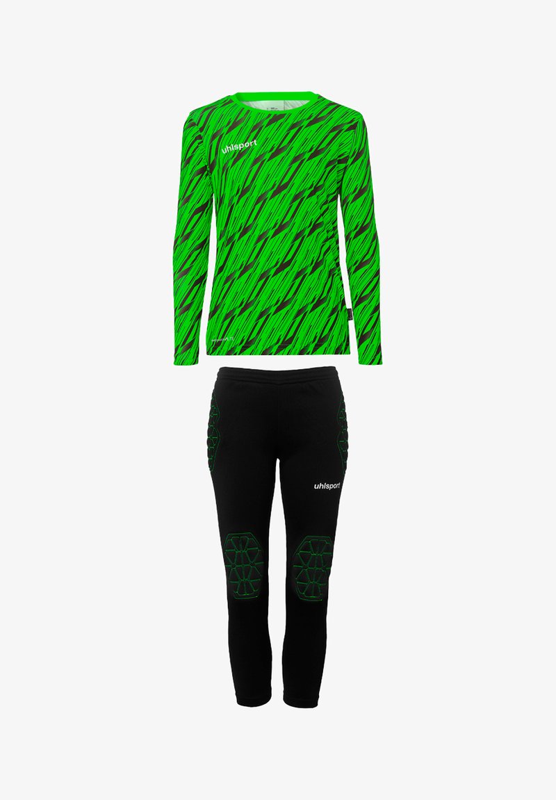 Haut à manches longues vert avec un motif en zigzag noir et vert, associé à un pantalon noir avec des accents verts et une protection des genoux rembourrée.