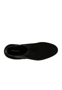 Scarpa nera slip-on in suede con una superficie liscia, punta tonda e accenti laterali elastici. Marchio visibile all'interno.