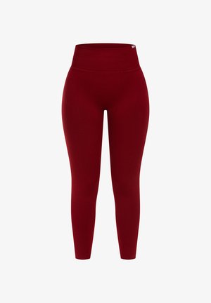 Punat leggingsit, jotka on valmistettu sileästä, joustavasta kankaasta. Korkea vyötärösuunnittelu, tiukat lahkeet ilman näkyviä kuvioita tai logoja.