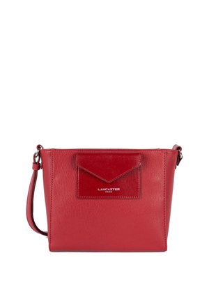 Red leather crossbody bag with a textured front pocket, smooth finish, adjustable strap, and embossed "Lancaster Paris" logo.