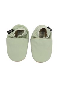 Lichtgroene leren babyslofjes met zachte elastische openingen, een ronde neus en een platte, antislip zool. Zwarte labels aan de zijkanten geven de maat aan.