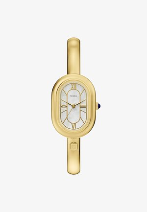 Dámské náramkové hodinky Fossil se zlatým kovovým pouzdrem, bílým dýhovým ciferníkem, geometrickými hodinovými indexy a modrým korunkovým akcentem.