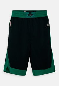 Sorte basketball shorts med grønne detaljer, fremstillet i et tekstureret meshstof, med NBA-logo og et kløvermønster på livet.
