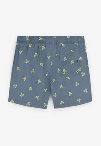 Pantaloni da bagno blu con cintura elastica. Presenta un motivo ripetuto di teschi verdi con ossa incrociate. Include una tasca posteriore.