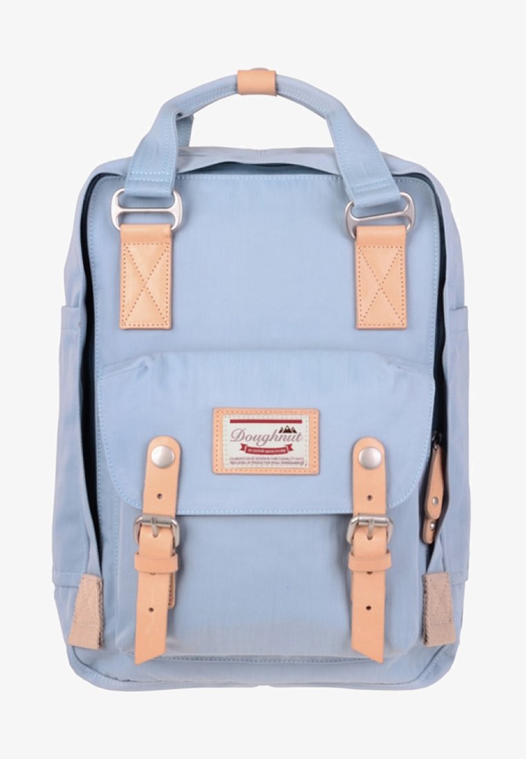 Mochila azul claro com detalhes em pele castanha, apresentando um bolso frontal, acessórios em metal e alças ajustáveis. Textura de tecido suave.