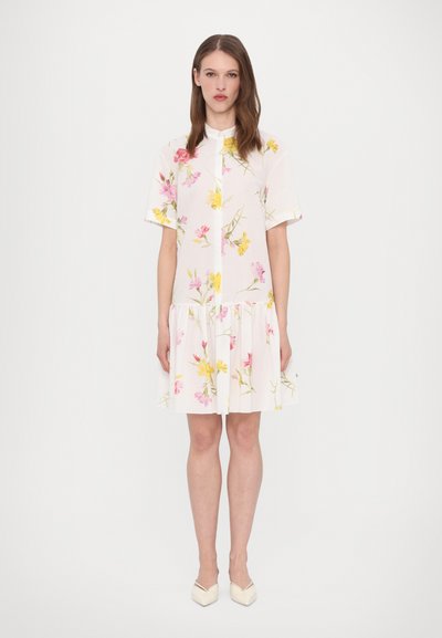 Floral dress in white with short sleeves, featuring pink and yellow flowers. Gathered skirt and collar detail, crafted from lightweight fabric.