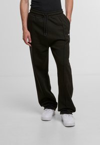 Black sweatpants with a drawstring waist, side pockets, and white logo detailing. Smooth texture and relaxed fit for comfort.