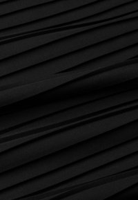 Black fabric with a pleated texture, featuring evenly spaced folds creating depth and dimension. Smooth and lightweight material.