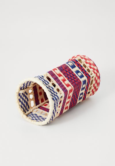 Woven basket in red, white, and blue patterns, cylindrical shape, with open lattice design and a smooth, textured finish.