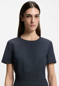 Dark navy short-sleeve dress featuring a round neckline, smooth textured fabric, and subtle vertical patterns.