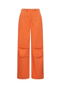 Wide-leg pants made of smooth, orange fabric. Features a drawstring waistband and two large, stitched pockets on the sides.